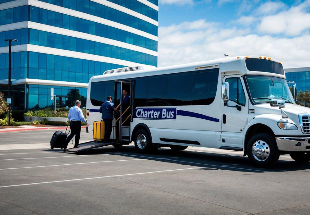 A charter bus parked in front of a corporate office building in San Diego, with a driver loading luggage and passengers boarding the bus